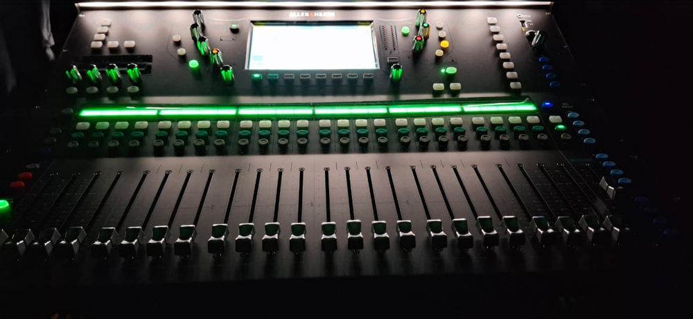 Allen & Heath SQ mixing console, faders and layer strips lit in green