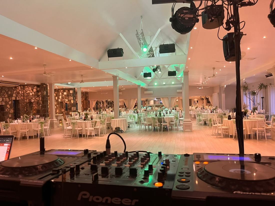 Hotel wedding reception hall with DJ decks and full lighting rig